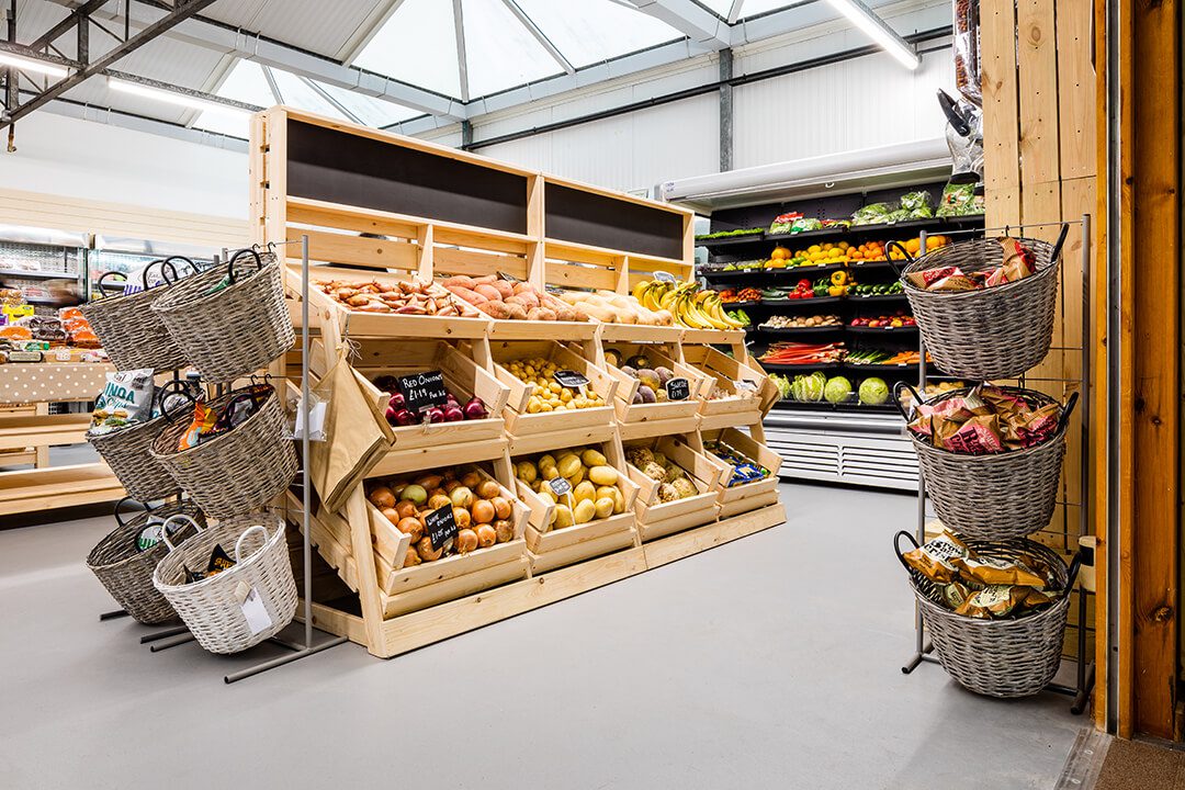 A view across the new farm shop at a garden centre showing the fresh produce on dispaly in custom built wooden displays