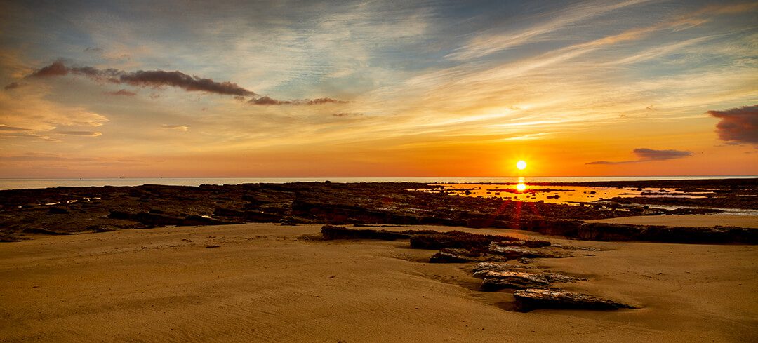 Sun rising over a beach in Northumberland.