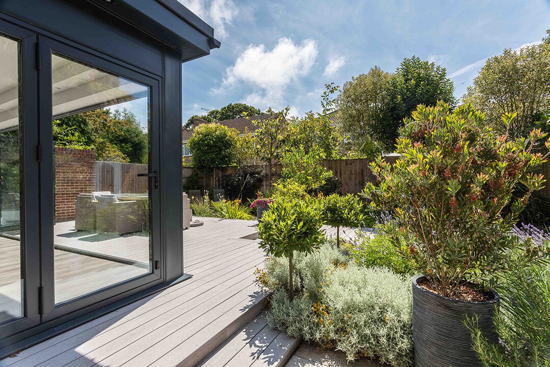 A view across a redesigned garden and garden room showing the varied planting.