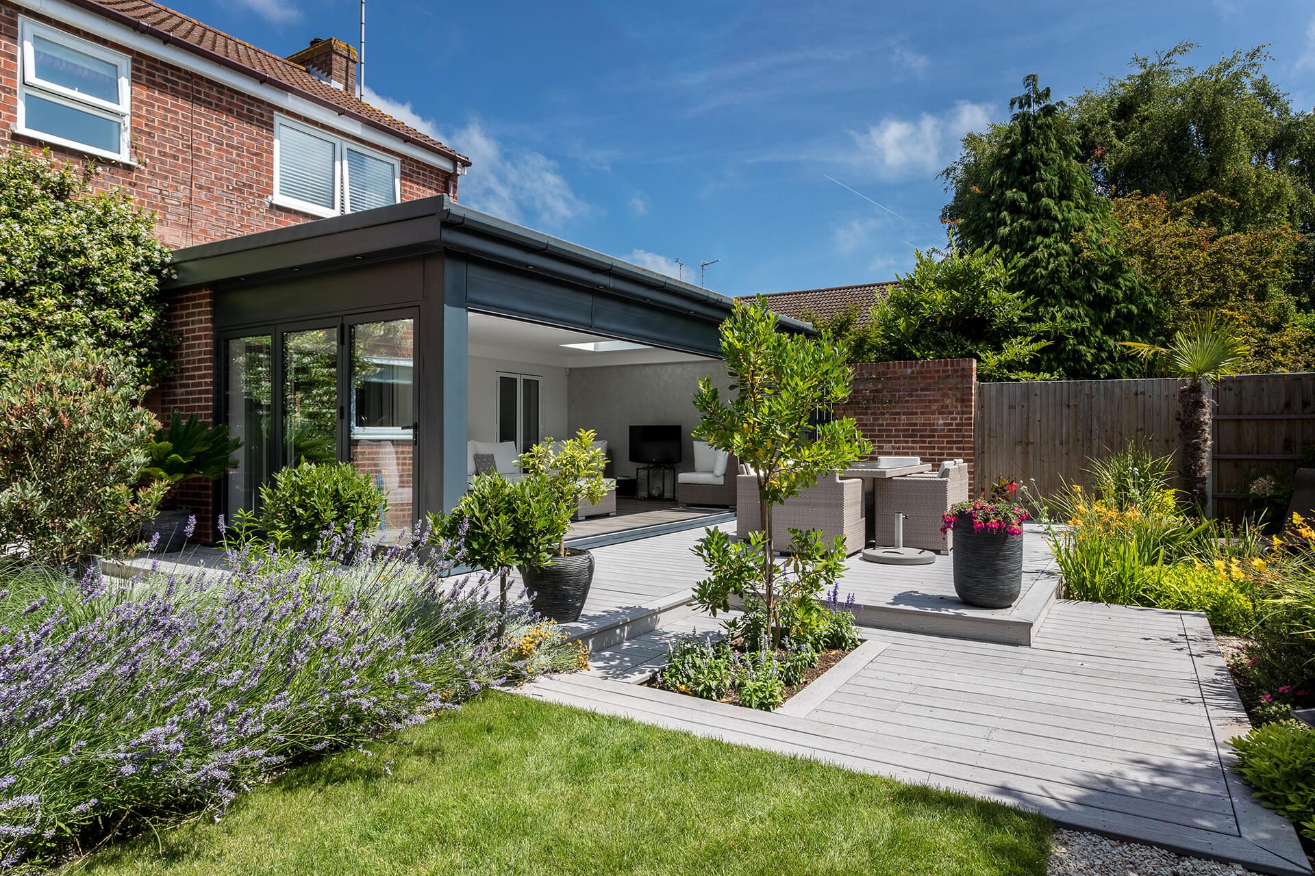 A redesigned garden featuring a garden room opened up to form a continous link to the house