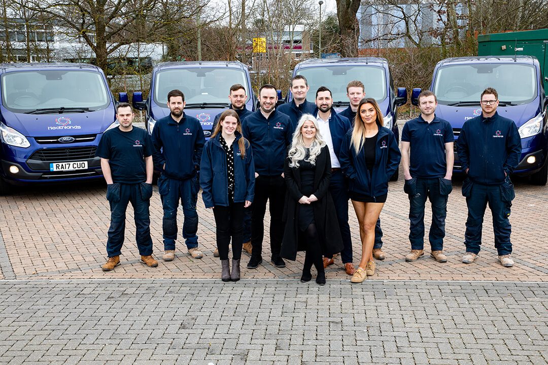 A group shot of the employees and directors of a plumbing company